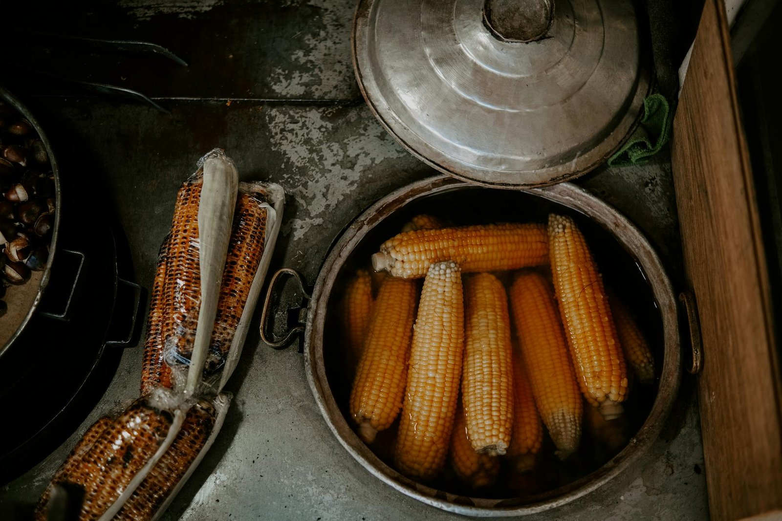 Top view of freshly boiled corn in a pot, perfect for food-themed projects.