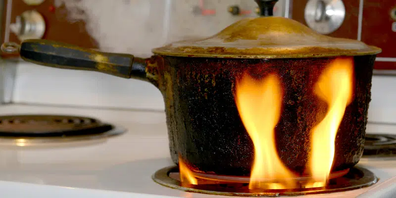 a sauce pan placed on electric stove getting fire
