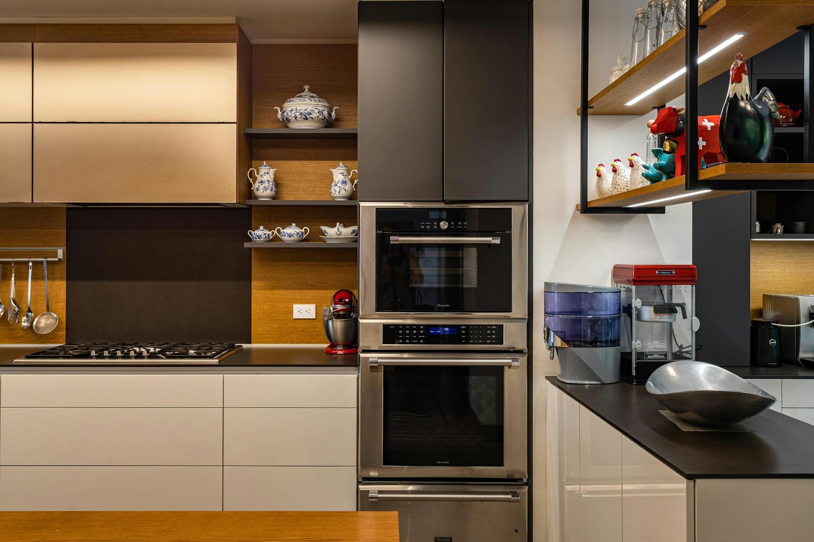 Contemporary kitchen design featuring sleek cabinets, dual ovens, and chic decor.