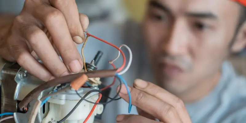 How to Spot and Fix Common Stove Electrical Problems 5 an electrician testing the electrical component