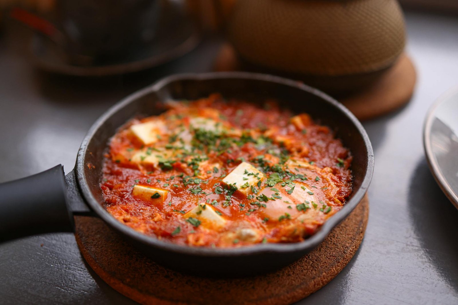 How to Season a Cast Iron Skillet for Non Stick Performance 1 Appetizing shakshuka in a skillet, topped with cheese and fresh herbs, perfect for a hearty breakfast.