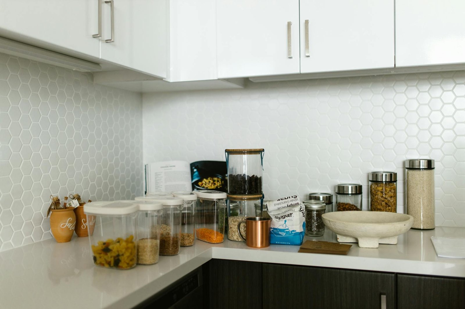 A neatly organized kitchen counter with various food storage containers.