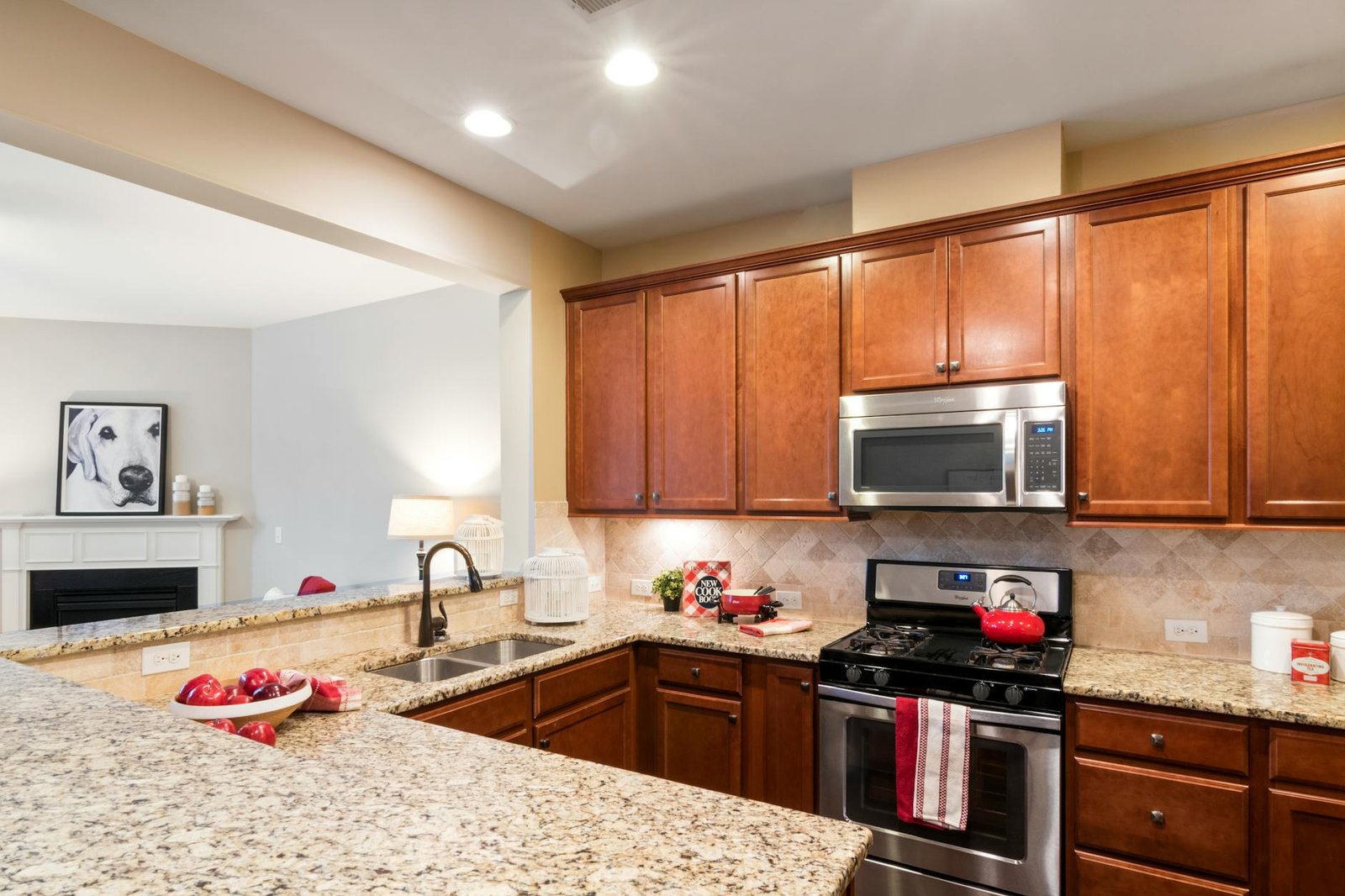 Stylish kitchen with granite countertops, wooden cabinets, and stainless steel appliances.