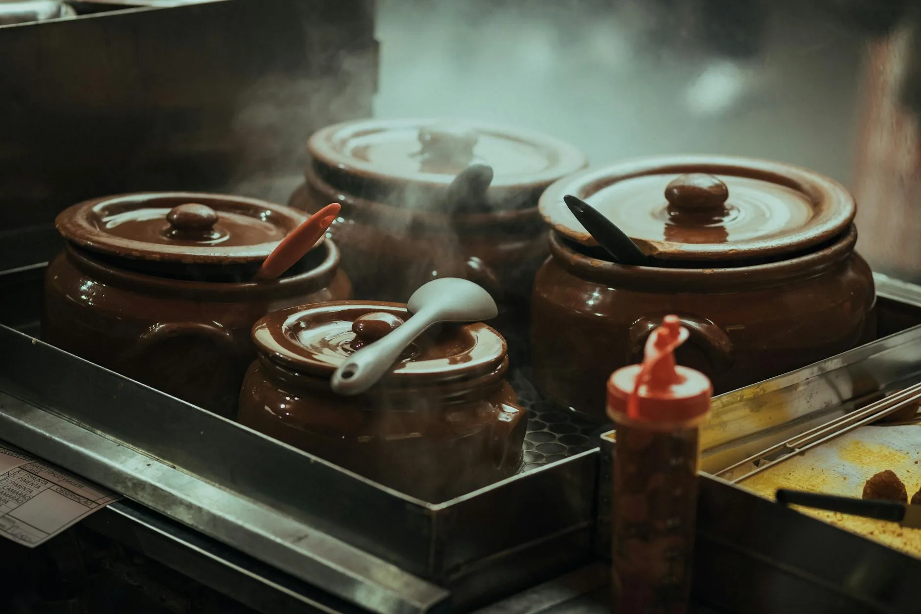 Steam rising from a simmering pot — small bubbles every 1-2 seconds is the visual cue of a true simmer between 180-205°F